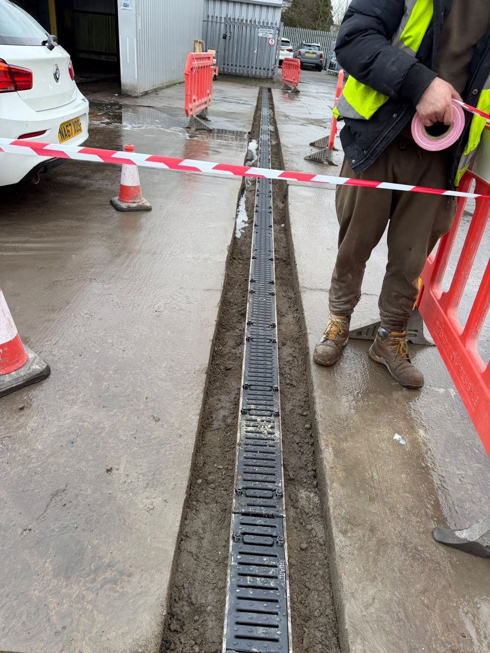 ACO channel drainage installed to a road with traffic management