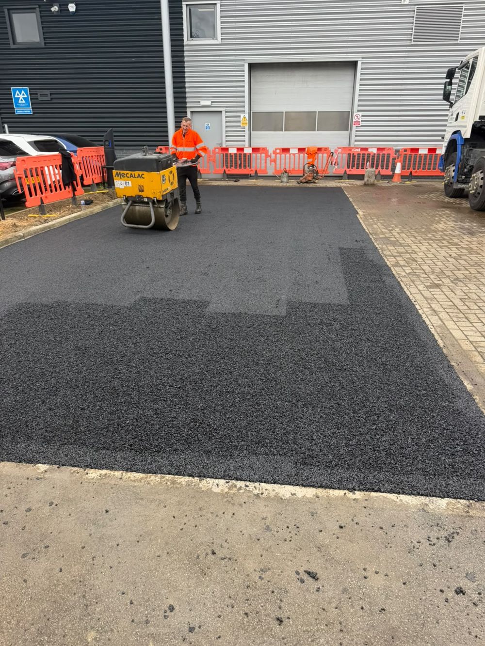 Fresh tarmac surfacing to a commercial yard