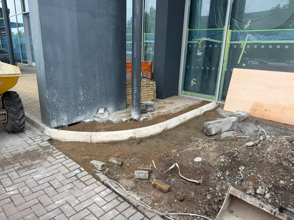 Concrete and paving works around a commercial building entrance