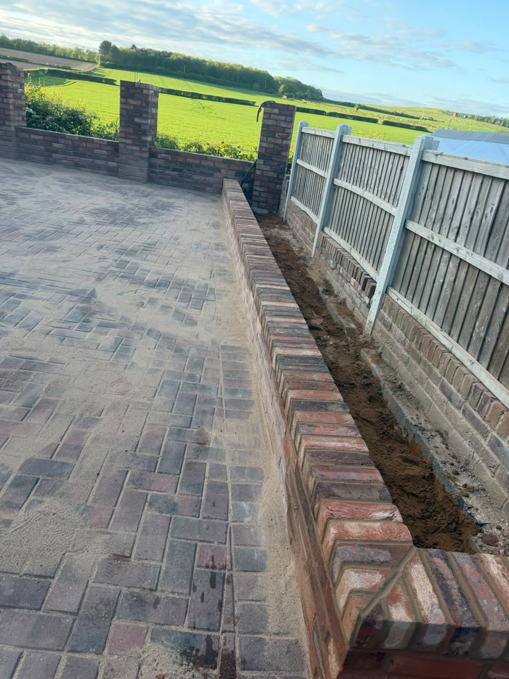 Brick retaining wall and drainage along a boundary