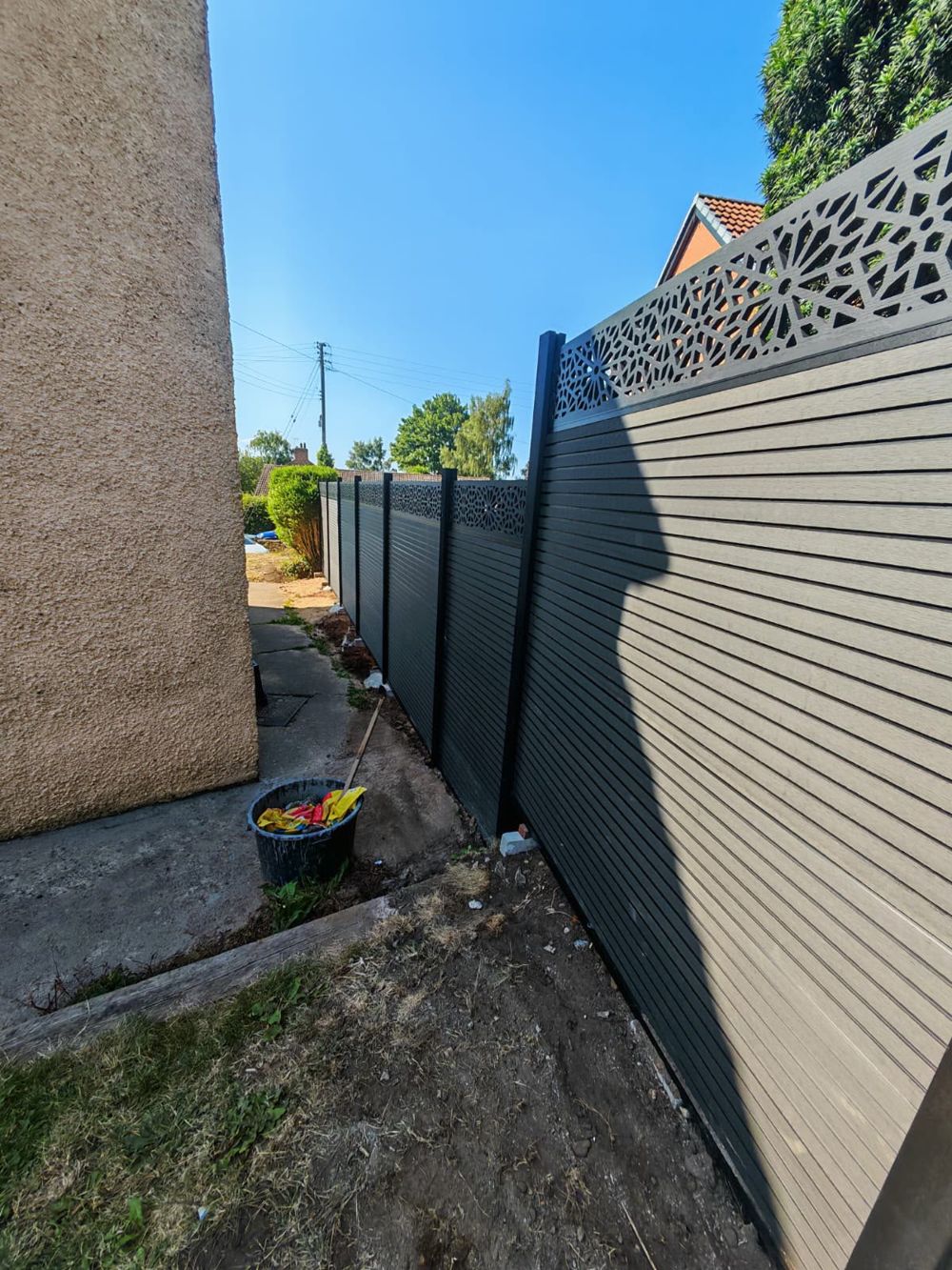Composite boundary fencing installed between properties