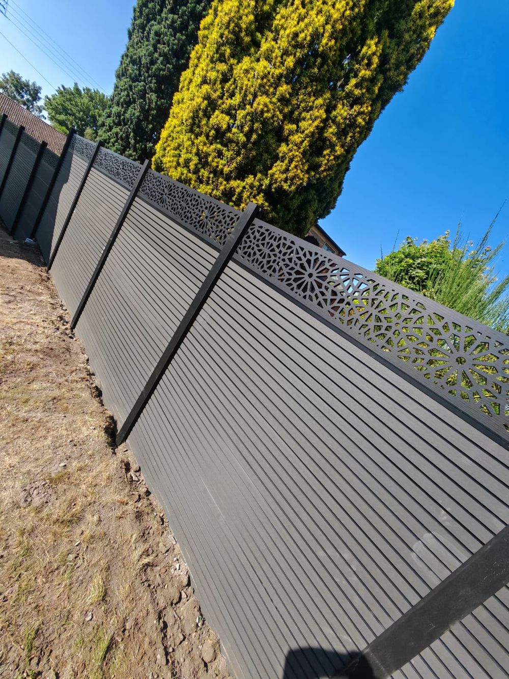 Completed composite fence line to a boundary